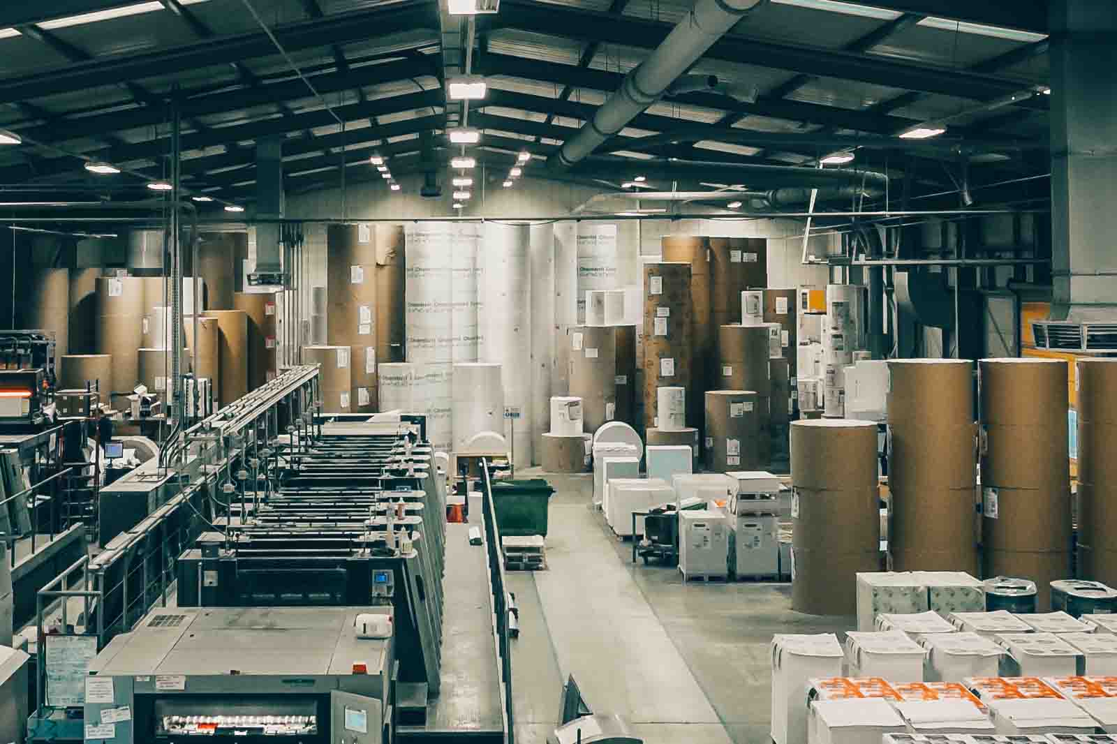 The inside of a factory with a lot of boxes and a printer.