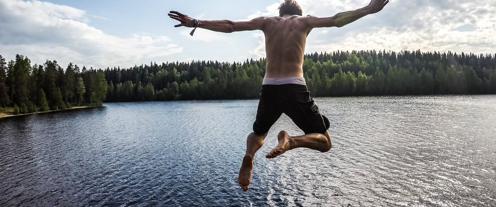 Person jumping into a lake