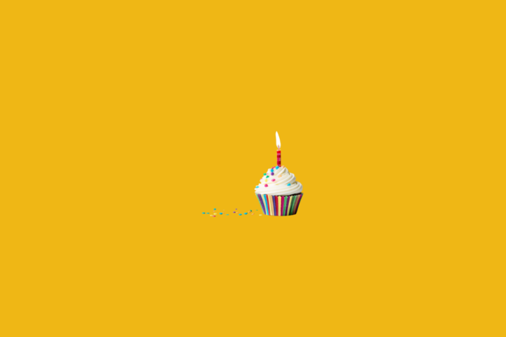 A yellow cupcake with a candle for Go Inspire's 30th birthday.