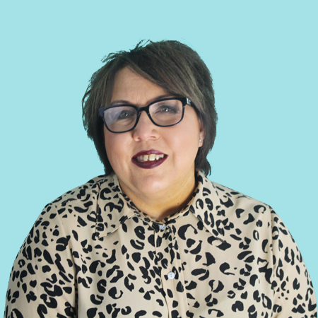 A woman wearing glasses and a leopard print shirt named Caroline Maddox.